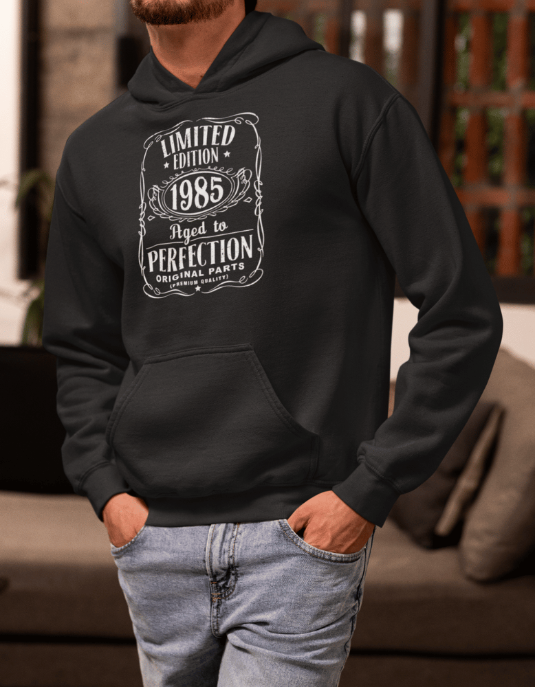 Black hoodie with “Limited Edition 1985 Aged to Perfection” white label design
